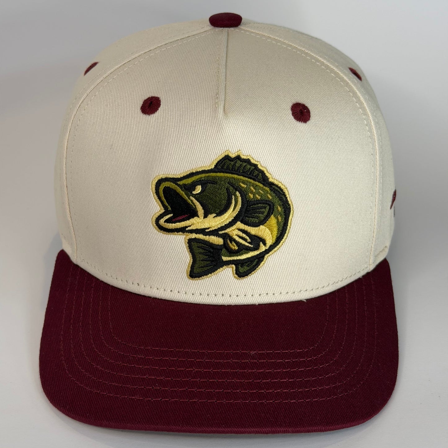 Beige and maroon cap with a fish logo on a white background